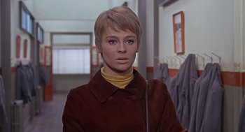 Movie still from “Fahrenheit 451” (1966), directed by François Truffaut – A woman with short blonde hair wearing a brown jacket; Close Up shot, Low angle