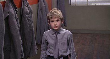 Movie still from “Fahrenheit 451” (1966), directed by François Truffaut – A young boy in a dress shirt and tie; Medium shot, Over the shoulder angle