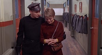 Movie still from “Fahrenheit 451” (1966), directed by François Truffaut – A man and a woman standing next to each other in a hallway; Medium shot, Over the shoulder angle
