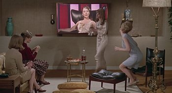 Movie still from “Fahrenheit 451” (1966), directed by François Truffaut – A group of people standing in front of a television; Wide shot, High angle