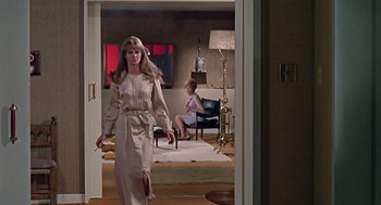 Movie still from “Fahrenheit 451” (1966), directed by François Truffaut – A woman is walking in a living room while another woman sits in a living room; Wide shot, Over the shoulder angle