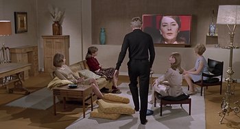 Movie still from “Fahrenheit 451” (1966), directed by François Truffaut – A group of people sitting in a living room watching television; Wide shot, Low angle