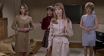 Movie still from “Fahrenheit 451” (1966), directed by François Truffaut – A group of women standing next to each other in a room; Medium shot, Low angle