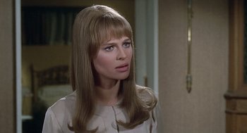 Movie still from “Fahrenheit 451” (1966), directed by François Truffaut – A woman with long blonde hair wearing a white dress; Close Up shot, Over the shoulder angle