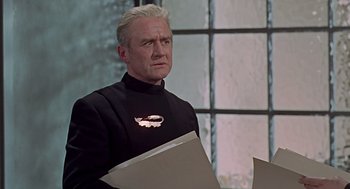 Movie still from “Fahrenheit 451” (1966), directed by François Truffaut – A man in a black jacket holding a piece of paper; Close Up shot, Low angle