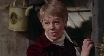 Movie still from “Fahrenheit 451” (1966), directed by François Truffaut – A woman in a red jacket is looking at the camera; Close Up shot, High angle