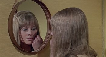 Movie still from “Fahrenheit 451” (1966), directed by François Truffaut – A woman looking in the mirror and touching her face; Close Up shot, Over the shoulder angle
