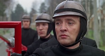 Movie still from “Fahrenheit 451” (1966), directed by François Truffaut – A group of men wearing helmets in a row; Close Up shot, Over the shoulder angle
