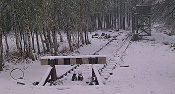Movie still from “Fahrenheit 451” (1966), directed by François Truffaut – A snow covered road with some steps leading up to it; Extreme Wide shot, High angle