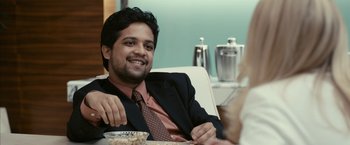 Movie still from “Fair Game” (2010), directed by Doug Liman – A man sitting at a table with a bowl in front of him; Close Up shot, Over the shoulder angle