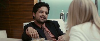 Movie still from “Fair Game” (2010), directed by Doug Liman – A man sitting at a table with food in front of him; Close Up shot, Over the shoulder angle