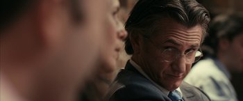 Movie still from “Fair Game” (2010), directed by Doug Liman – A person wearing a suit and glasses; Close Up shot, Over the shoulder angle