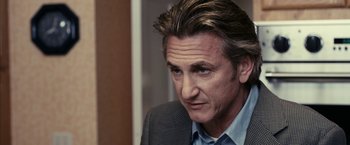 Movie still from “Fair Game” (2010), directed by Doug Liman – A person wearing a suit and tie; Close Up shot, Over the shoulder angle