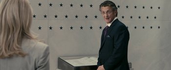 Movie still from “Fair Game” (2010), directed by Doug Liman – A man standing next to a box of papers in a room; Medium shot, Over the shoulder angle