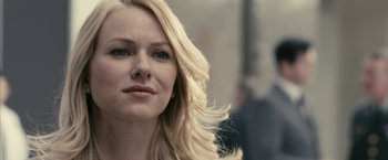 Movie still from “Fair Game” (2010), directed by Doug Liman – A woman with long blonde hair and blue eyes looking at the camera; Close Up shot, Over the shoulder angle