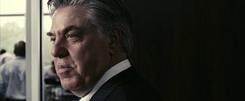 Movie still from “Fair Game” (2010), directed by Doug Liman – An older man wearing a suit and tie; Close Up shot, Low angle