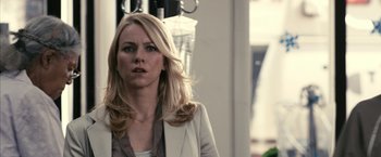 Movie still from “Fair Game” (2010), directed by Doug Liman – A woman with long blonde hair wearing a white jacket; Close Up shot, Over the shoulder angle