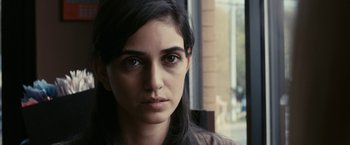 Movie still from “Fair Game” (2010), directed by Doug Liman – A person with long black hair; Close Up shot, Over the shoulder angle
