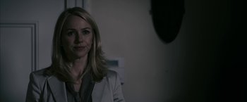 Movie still from “Fair Game” (2010), directed by Doug Liman – A woman with blonde hair is posing for a picture; Close Up shot, Over the shoulder angle