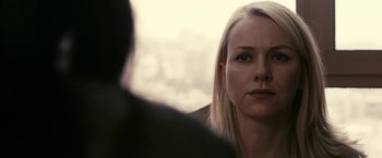 Movie still from “Fair Game” (2010), directed by Doug Liman – A person looking at a camera; Close Up shot, Over the shoulder angle