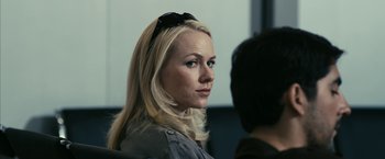 Movie still from “Fair Game” (2010), directed by Doug Liman – A woman with long blonde hair wearing sunglasses; Close Up shot, Over the shoulder angle