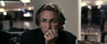 Movie still from “Fair Game” (2010), directed by Doug Liman – A person wearing glasses and a ring; Close Up shot, Over the shoulder angle
