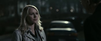 Movie still from “Fair Game” (2010), directed by Doug Liman – A woman standing in front of a car at night; Close Up shot, Over the shoulder angle