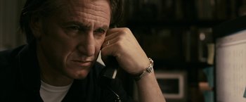 Movie still from “Fair Game” (2010), directed by Doug Liman – A person talking on a phone; Close Up shot, Low angle