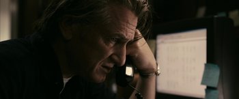 Movie still from “Fair Game” (2010), directed by Doug Liman – A person talking on a phone; Close Up shot, High angle