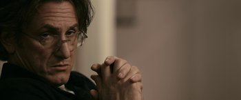 Movie still from “Fair Game” (2010), directed by Doug Liman – A person with their hands clasped together; Close Up shot, Over the shoulder angle