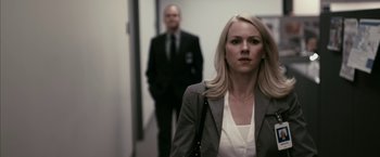 Movie still from “Fair Game” (2010), directed by Doug Liman – A woman and a man in a suit and tie in a hallway; Close Up shot, Over the shoulder angle