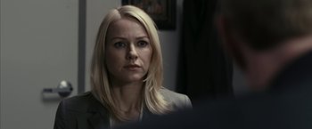 Movie still from “Fair Game” (2010), directed by Doug Liman – A woman with blonde hair is looking at the camera; Close Up shot, Over the shoulder angle