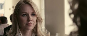 Movie still from “Fair Game” (2010), directed by Doug Liman – A woman with long blonde hair and blue eyes looking at the camera; Close Up shot, Over the shoulder angle