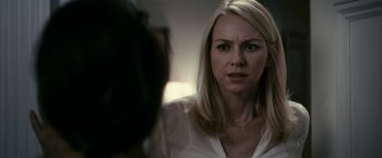 Movie still from “Fair Game” (2010), directed by Doug Liman – A woman looking at the camera with a sad look on her face; Close Up shot, Over the shoulder angle