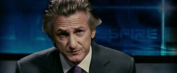 Movie still from “Fair Game” (2010), directed by Doug Liman – A man in a suit and purple tie looking to his left; Close Up shot, Over the shoulder angle