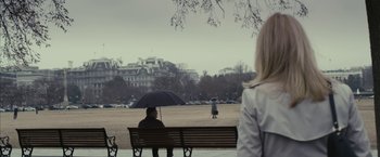 Movie still from “Fair Game” (2010), directed by Doug Liman – Two people are sitting on a bench under an umbrella; Extreme Wide shot, Over the shoulder angle