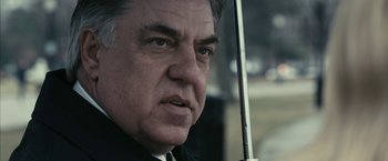 Movie still from “Fair Game” (2010), directed by Doug Liman – A person holding a stick; Close Up shot, Low angle