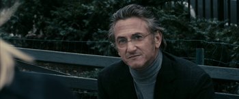 Movie still from “Fair Game” (2010), directed by Doug Liman – A person sitting on a park bench; Close Up shot, Over the shoulder angle