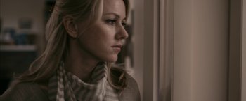 Movie still from “Fair Game” (2010), directed by Doug Liman – A beautiful blonde haired woman wearing a striped sweater; Close Up shot, Over the shoulder angle