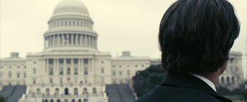 Movie still from “Fair Game” (2010), directed by Doug Liman – A person standing in front of the capitol building; Close Up shot, Low angle