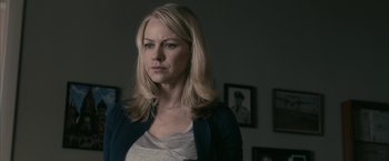 Movie still from “Fair Game” (2010), directed by Doug Liman – A woman with blonde hair and a white shirt; Close Up shot, Over the shoulder angle