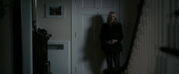 Movie still from “Fair Game” (2010), directed by Doug Liman – A woman standing in front of a white door; Wide shot, Over the shoulder angle