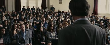 Movie still from “Fair Game” (2010), directed by Doug Liman – A group of people sitting in front of an audience; Wide shot, High angle