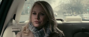 Movie still from “Fair Game” (2010), directed by Doug Liman – A beautiful blonde woman sitting in the back seat of a car; Close Up shot, Over the shoulder angle