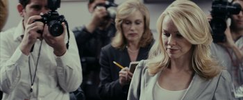 Movie still from “Fair Game” (2010), directed by Doug Liman – A woman is holding a pencil and looking at her cell phone; Close Up shot, Over the shoulder angle