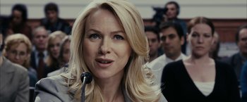 Movie still from “Fair Game” (2010), directed by Doug Liman – A woman with blonde hair is giving a speech; Close Up shot, Over the shoulder angle