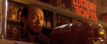 Movie still from “Falling Down” (1993), directed by Joel Schumacher – A man sitting on a couch in a room; Close Up shot, Low angle