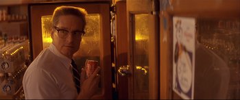Movie still from “Falling Down” (1993), directed by Joel Schumacher – A man holding a cup of coffee in a room; Close Up shot, Low angle