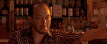 Movie still from “Falling Down” (1993), directed by Joel Schumacher – A person sitting in front of a bar; Close Up shot, Low angle