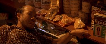 Movie still from “Falling Down” (1993), directed by Joel Schumacher – A person sitting in front of a table filled with food; Close Up shot, High angle